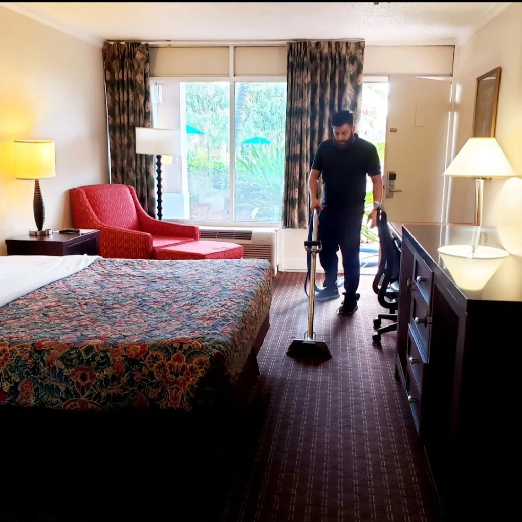 Cleaning the carpet of a hotel guest room